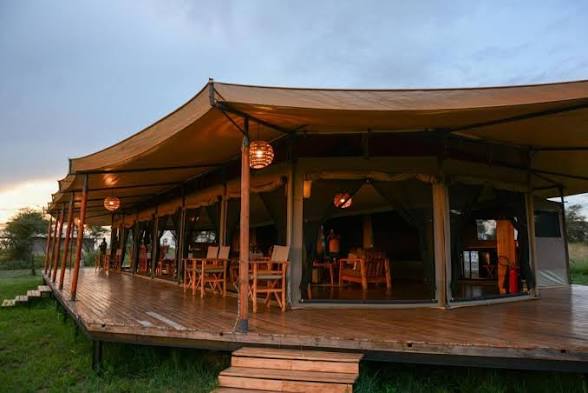 Luxury tented camp accommodation with warm interior lighting during an African safari in Tanzania