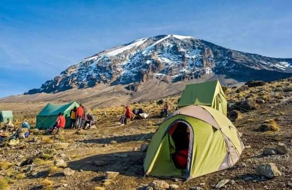 Camping tent on the slopes of Mount Kilimanjaro during a trekking a tour in Tanzania